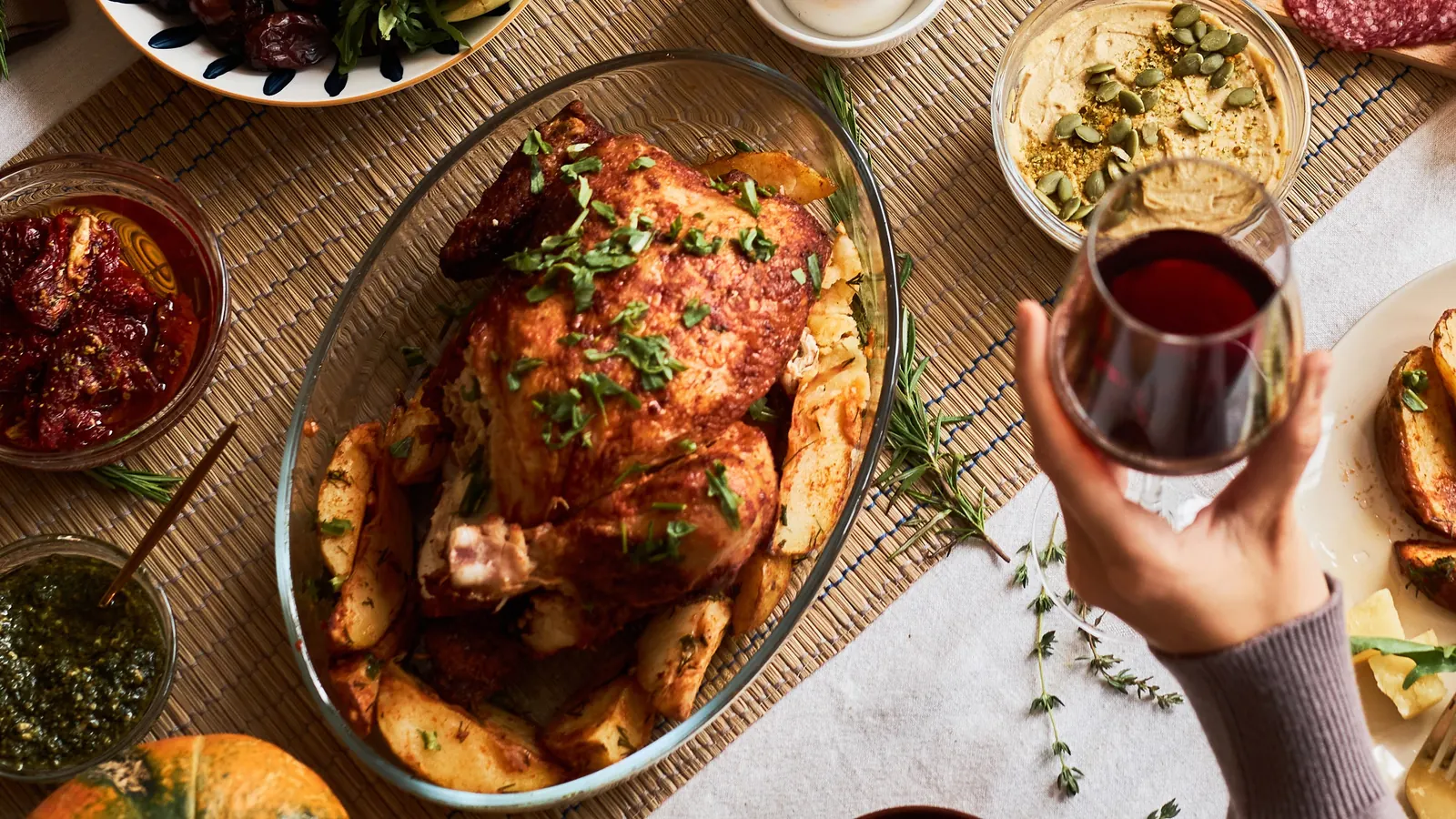 A golden roast bird with roast potatoes on a festive table
