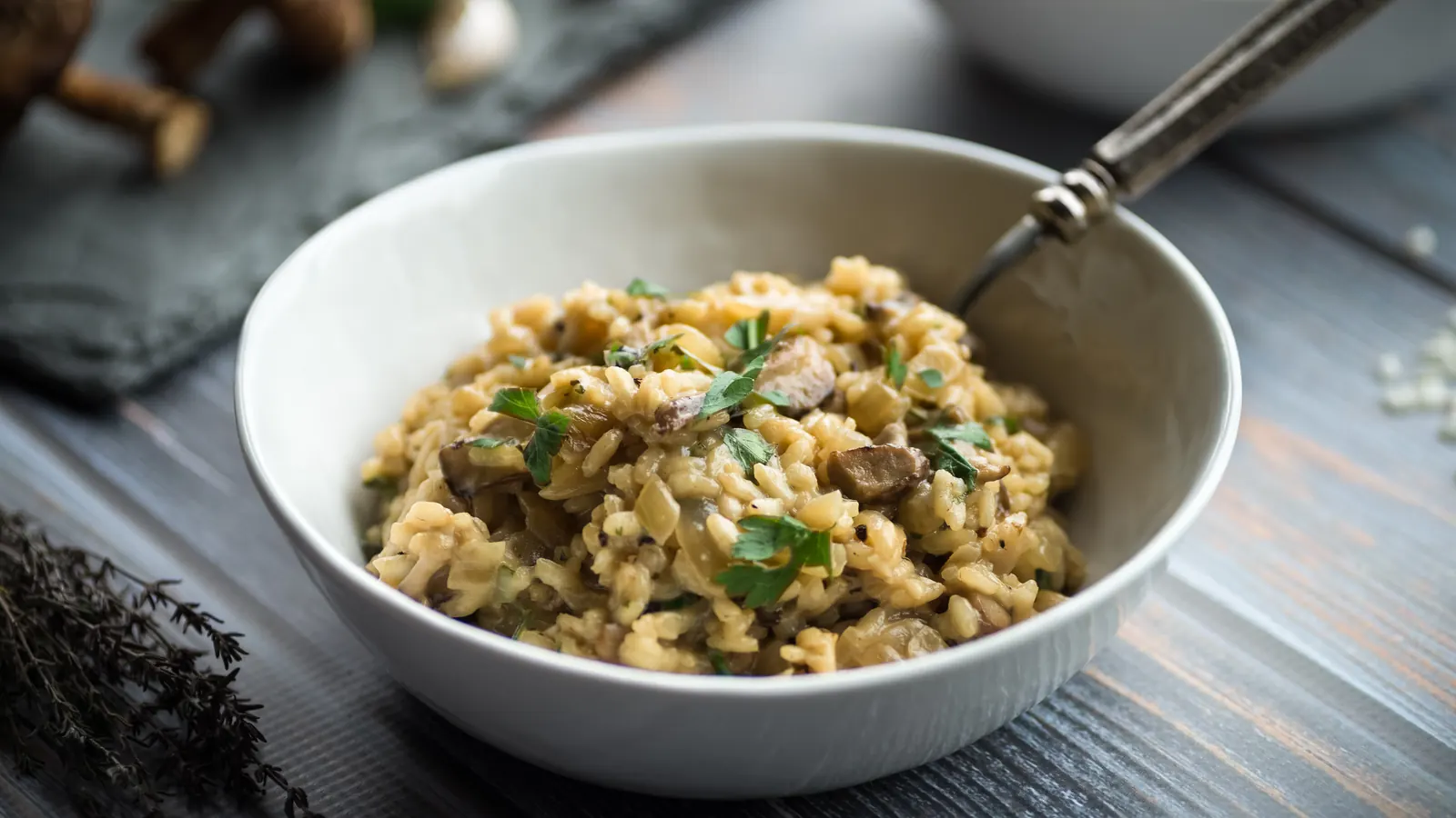 A bowl of creamy mushroom risotto topped with parsley